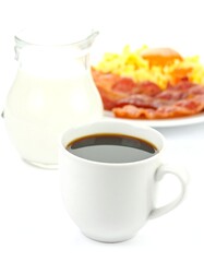 Morning meal with coffee, milk, and bacon