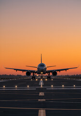 A majestic airplane preparing for takeoff silhouetted against a breathtaking sunrise ready for adventure in a golden