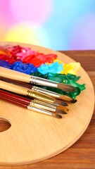 Obraz premium Paintbrushes and palette on wood