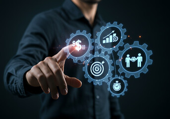 A person interacts with a holographic display of interconnected gears representing business processes, including financial growth, targets, and collaboration.