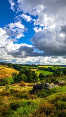 Fototapeta premium Panoramic view of a landscape with hills, trees, and clouds
