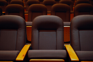 Fototapeta premium Rows of Empty Chairs in a Movie Theater Cinema Hall. Theater with rows of chairs ready to receive spectators