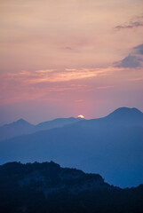 Fototapeta premium Sunset over the mountains with colorful sky and misty landscape