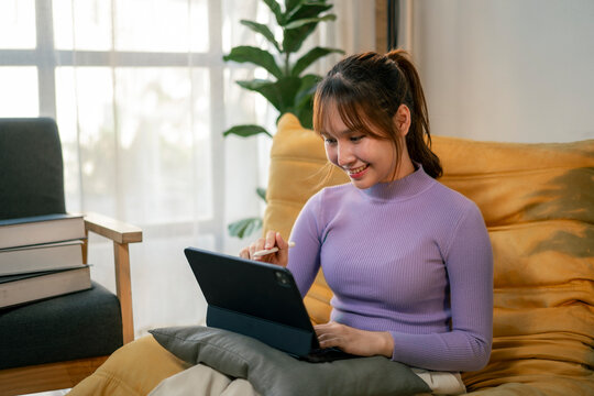 Young designer working from home using digital tablet and stylus