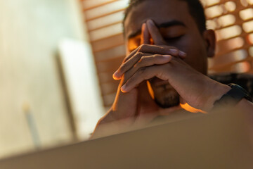 Obraz premium Businessman stressed, sad, and tired after financial trade fail. Concept of lose, problem, and broken dreams in business and remote working with notebook. Depicts failure and struggle in modern work.