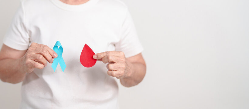 Elderly woman with Blue ribbon and red Blood drop for World Diabetes Day, Blue November Health, Prostate Cancer awareness, Blood sugar check, Insulin, Glucose screening, donation and Health checkup - Powered by Adobe