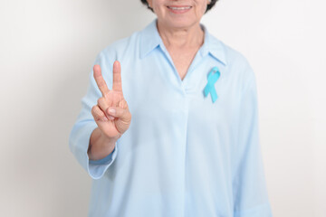 Elderly with blue Ribbon for concept of blue November, November Prostate Cancer Awareness month,...