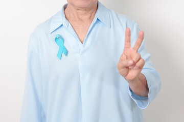 Elderly with blue Ribbon for concept of blue November, November Prostate Cancer Awareness month,...