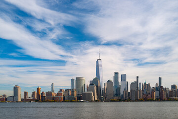 Obraz premium New York City cloudy skyline. NYC skyscrapers. Manhattan. NY cityscape with clouds. Downtown New York buildings. NYC skyline on clouds. New York harbor view. Skyscrapers in Manhattan. NYC downtown.