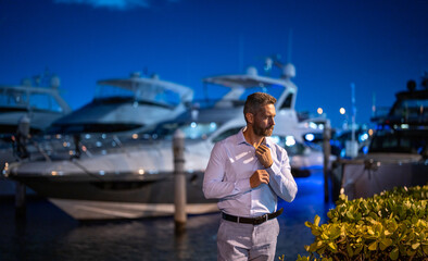 Rich millionaire man near yacht. Wealthy charismatic millionaire business man with luxury...