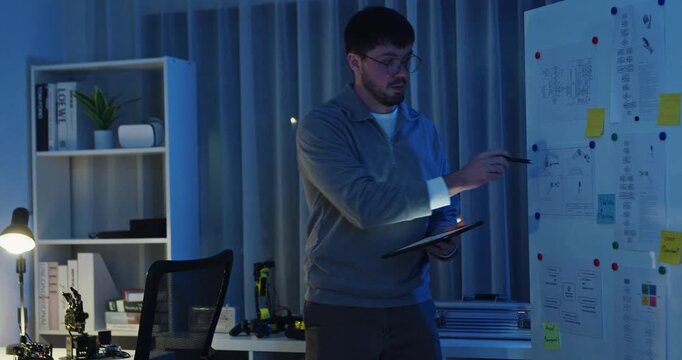 Team adult male engineer develop present AI robotics hand project at tech workspace night. Artificial intelligence, collaboration support prototype development, robotic, machine learn, training.