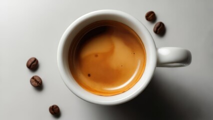 Espresso in white cup, coffee beans scattered