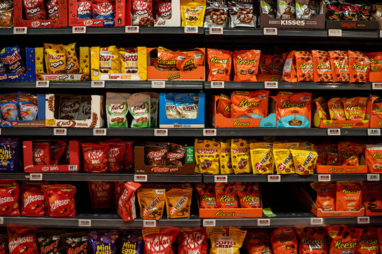 Assorted chocolate candy bags including Reeses, KitKat, Aero, Hersheys, Rolo and Oh Henry on supermarket shelf. Toronto, Canada - September 20, 2025.