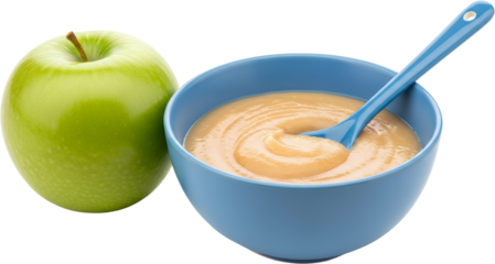 A whole green apple sits next to a blue bowl filled with smooth apple puree and a blue spoon isolate