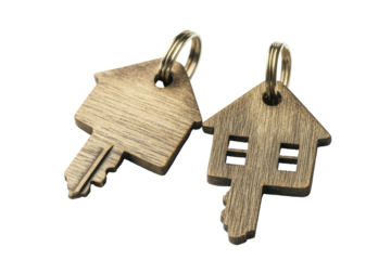 Golden house shaped keys isolated on transparent background. Two house keys isolated on white background.