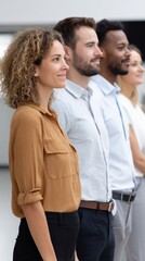 Obraz premium Diverse business colleagues standing side by side in open-plan office, teamwork concept. 