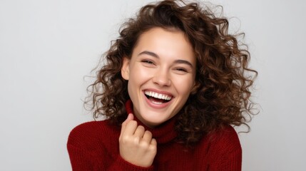 Happy young woman, curly-haired, laughing with a joyful expression, perfect for a marketing campaign. 