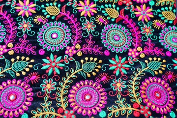 Embroidered floral design on velvet fabric, wide angle