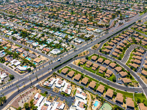 Top down aerial view of luxury homes with swimming pools in Palm Springs, California, showing geometric street layout and suburban symmetry