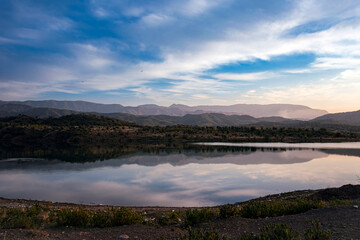 Scenic mountain landscape with lake reflection at sunset