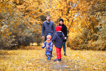 Fototapeta premium Family in autumn park in the afternoon