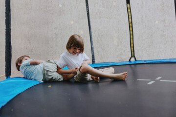 Happy children playing on a trampoline, enjoying laughter and gaining joy through playful...