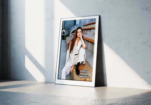 Modern Photo Frame Mockup Leaning on a Concrete Wall