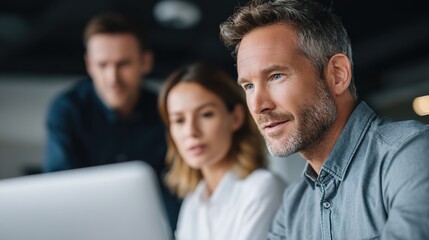 Team Collaboration in Modern Office Environment with Laptop Use