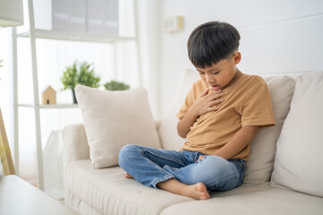 Obraz premium Asian boy touching throat and pain expression, sore throat symptom in children, flu or respiratory illness, school age health, influenza, virus, covid-19, pediatric doctor consultation, home care