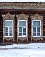 Ornate wooden windows in snow