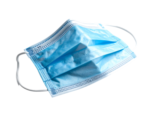 Light blue disposable face mask, slightly crumpled, with elastic ear loops, isolated on black background