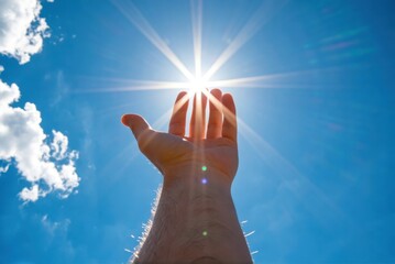 Reaching for the sun a hand against the sky nature photography bright environment inspirational viewpoint