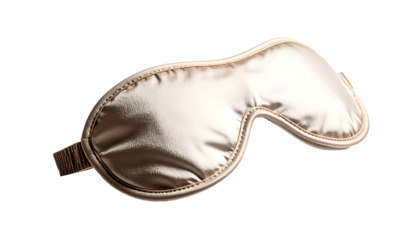 A champagne-gold satin sleep mask with an elastic band, softly curved, and a subtle sheen, floating against a black background