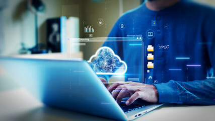 A person typing on a laptop with a digital cloud interface, symbolizing cloud computing, online data storage, file sharing, and secure digital networks.
