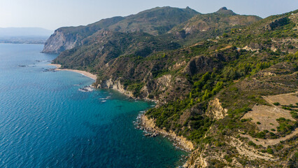 Aerial panorama of Ionian coastline featuring rugged cliffs rolling hills and secluded coves on...