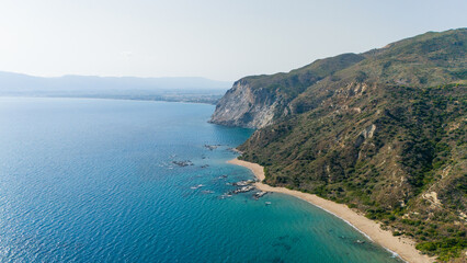 Fototapeta premium Turquoise waters crashing against steep cliffs and hidden beaches aerial view of untouched natural beauty in Zakynthos Greece