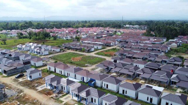 Aerial view of a residential area, some of which is still under construction, surrounded by agricultural areas
