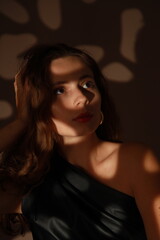 Close portrait of beautiful young brunette woman with shadow mask on her face