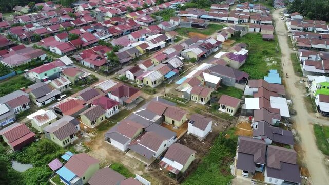 Aerial view of a residential area, some of which is still under construction, surrounded by agricultural areas