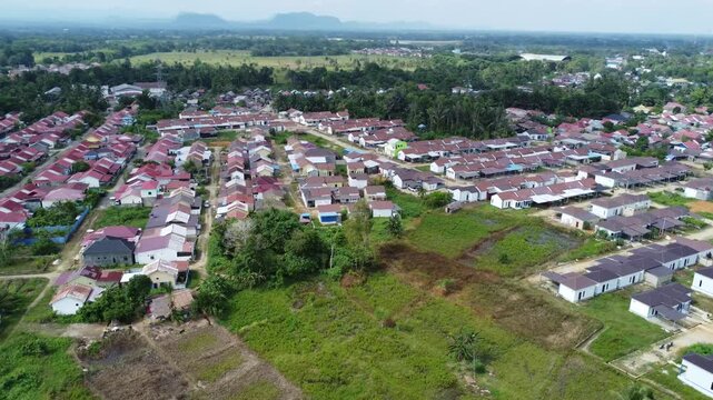 Aerial view of a residential area, some of which is still under construction, surrounded by agricultural areas