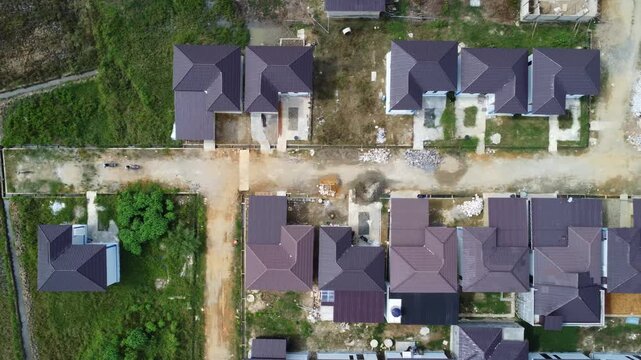 Aerial view of a residential area, some of which is still under construction, surrounded by agricultural areas