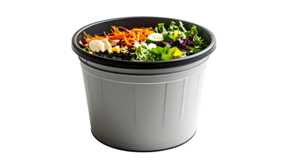 Light gray plastic compost bin with various food scraps, including shredded carrots, lettuce, and egg whites, layered inside a dark gray inner liner
