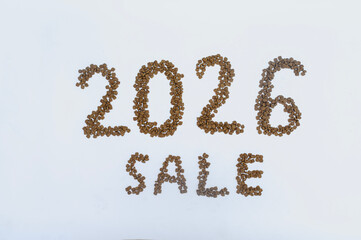Calendar 2026 from Dry pet food on a white background. Granules of good nutrition for dogs and cats. Food for the animals. Brown homogeneous pieces of dry food in the shape of numbers