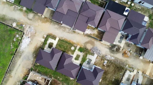 Aerial view of a residential area, some of which is still under construction, surrounded by agricultural areas