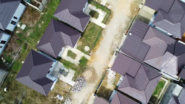 Aerial view of a residential area, some of which is still under construction, surrounded by agricultural areas