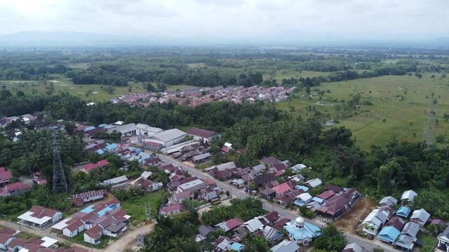Aerial view of a residential area, some of which is still under construction, surrounded by agricultural areas