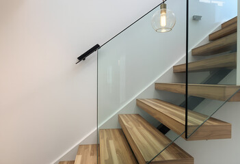 Modern Minimalist Wooden Staircase with Glass Railing and Pendant Light