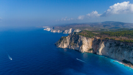 Stunning aerial of Myzithres Zakynthos Greece with limestone cliffs turquoise water sandy shore and endless Ionian Sea meeting the horizon