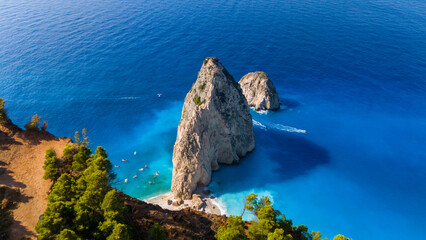 Myzithres Zakynthos Greece aerial view with twin limestone rocks turquoise shallow bay golden sand beach and deep blue Ionian Sea in sunlight