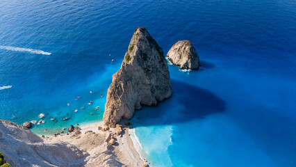 Myzithres Zakynthos Greece aerial view with towering limestone rocks turquoise shallow bay white sandy beach and deep blue Ionian Sea horizon